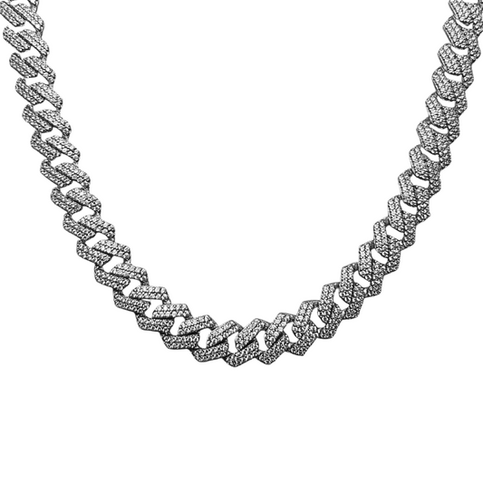 A silver cuban link chain necklace with intricate design and diamond embellishments.